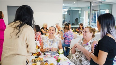 Attendees networking at the International Women's Day event