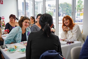 Attendees networking at the International Women's Day high tea event at Fairfield City HQ