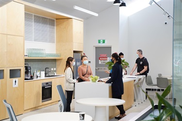 Staff and guests chatting in kitchen area during Fairfield City HQ launch