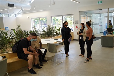 Staff and guests conversing in Fairfield City HQ during launch