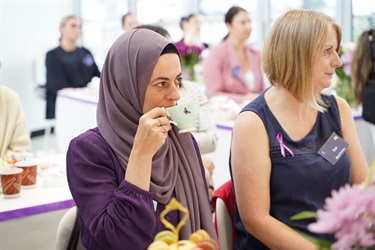 Guest drinking tea at International Womens Day High Tea in Fairfield City HQ