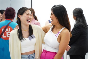 Influencer Jenny Dinh laughing with guest during International Womens Day High Tea in Fairfield City HQ