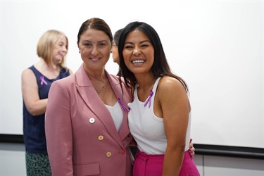 Jenny Dinh laughing posing with guest during International Womens Day High Tea in Fairfield City HQ