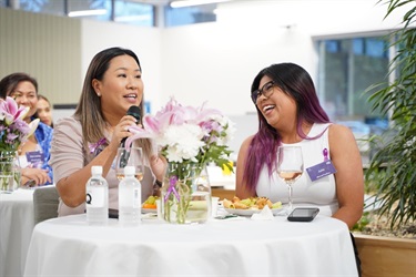 Guests-sitting-on-a-table-laughing-during-International-Womens-Day-After-5-Networking-event-in-Fairfield-City-HQ.jpg