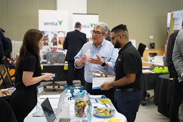 Attendees conversing at SkillsRoad Expo at Fairfield City HQ