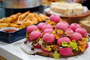 Catering platters of mini hamburgers and samosas