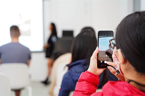 Attendee takes photos of Jenny Dinh during workshop at Fairfield City HQ