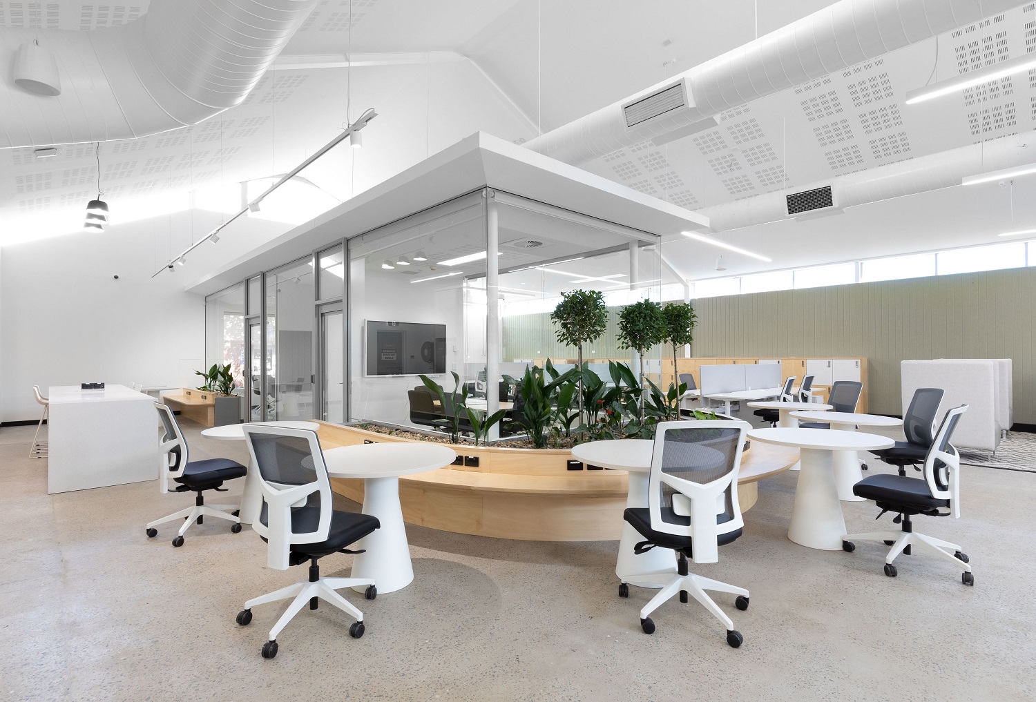 Hot desks surrounding private meeting room in Fairfield City HQ